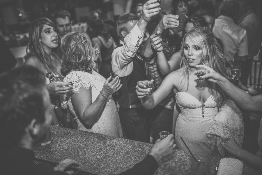 bride doing a shot in a cabin