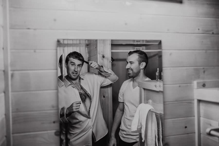 grooms getting ready reflextion in the mirror