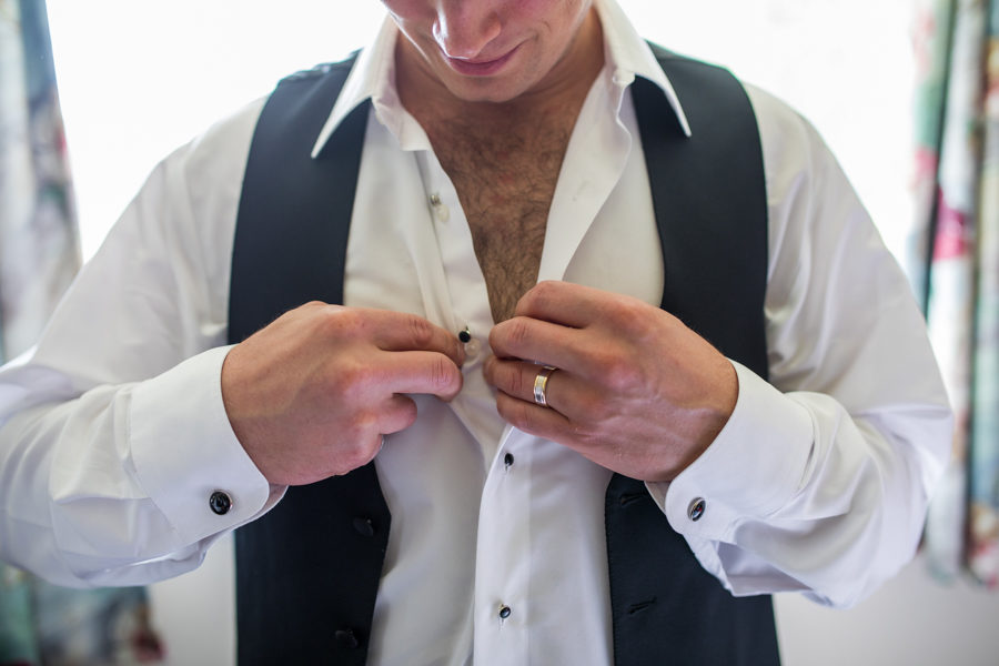 groom doing up his shirt on Cape Breton Island, The inverary resort