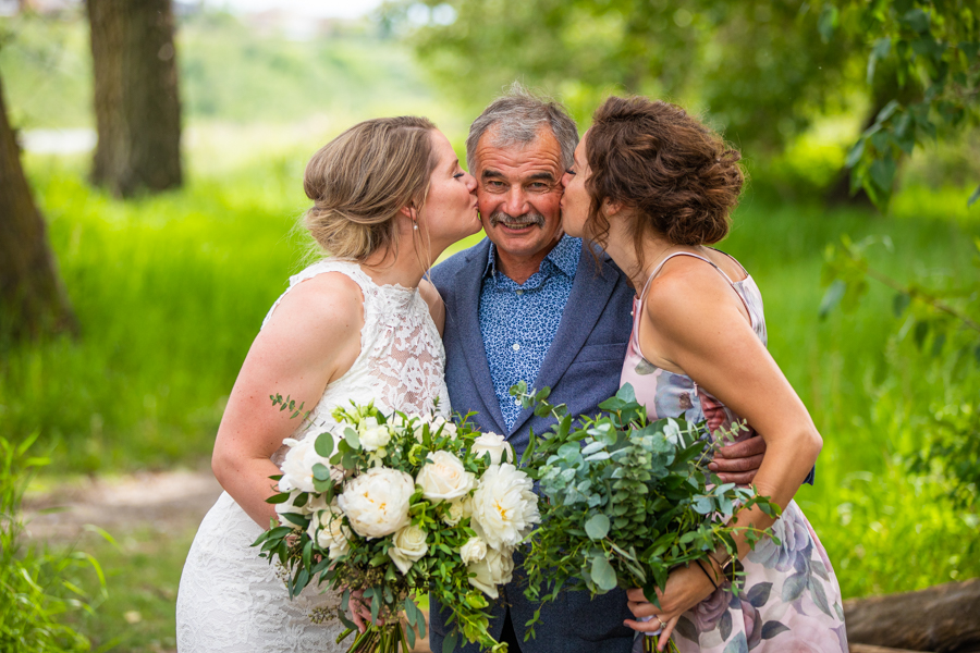 sisters give dad a kiss