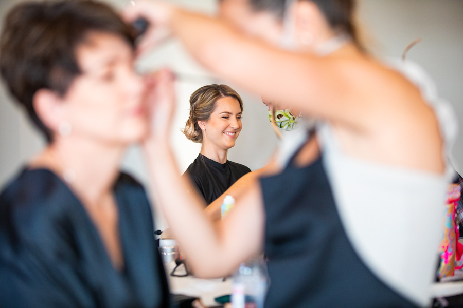bride getting make up done by Blush and coco
