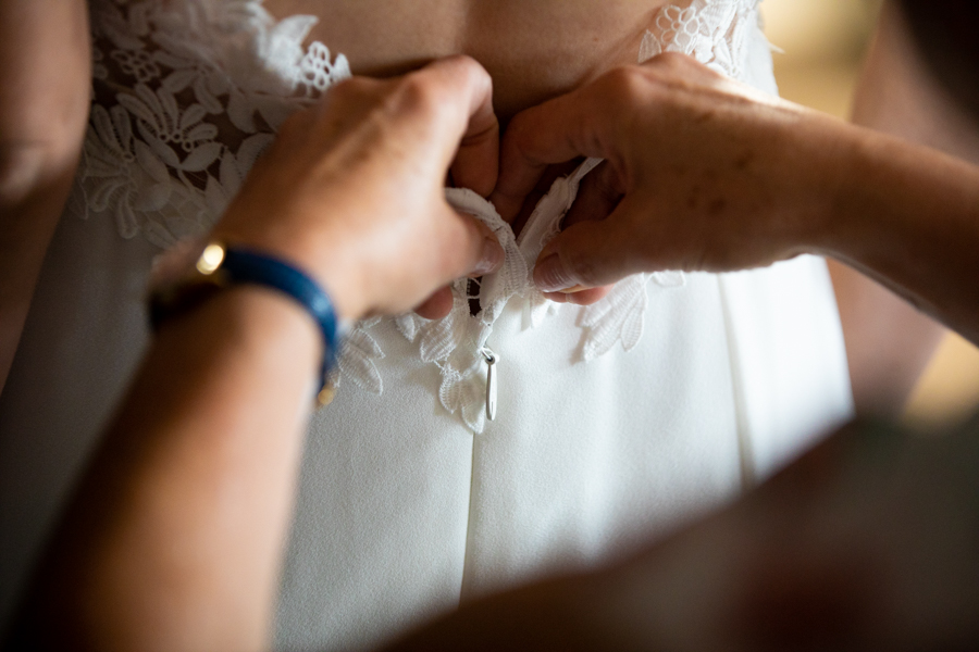 bride doing up her dress