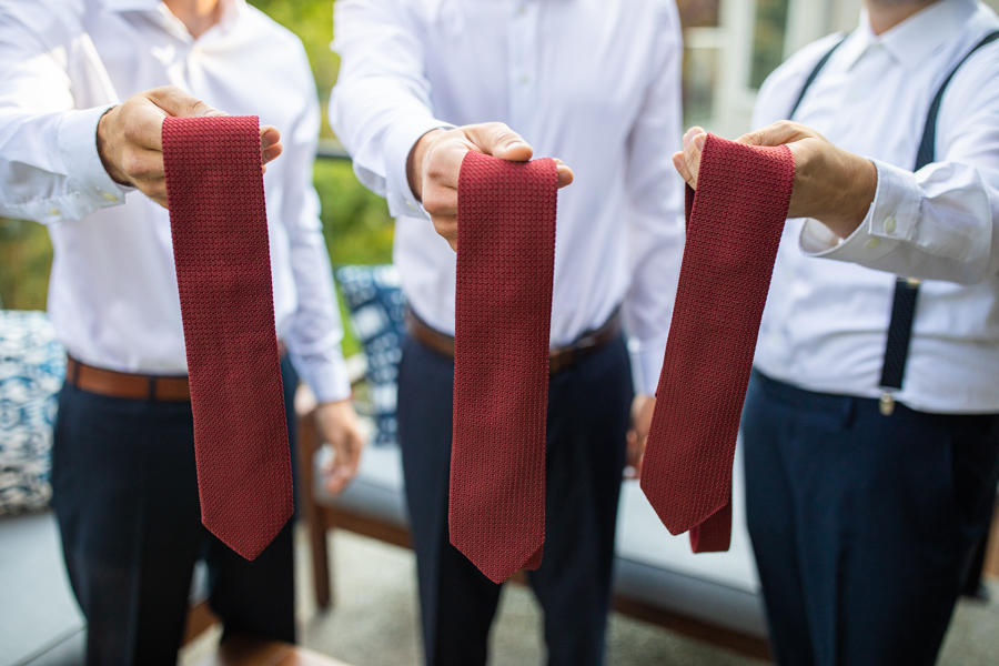groom holding ties