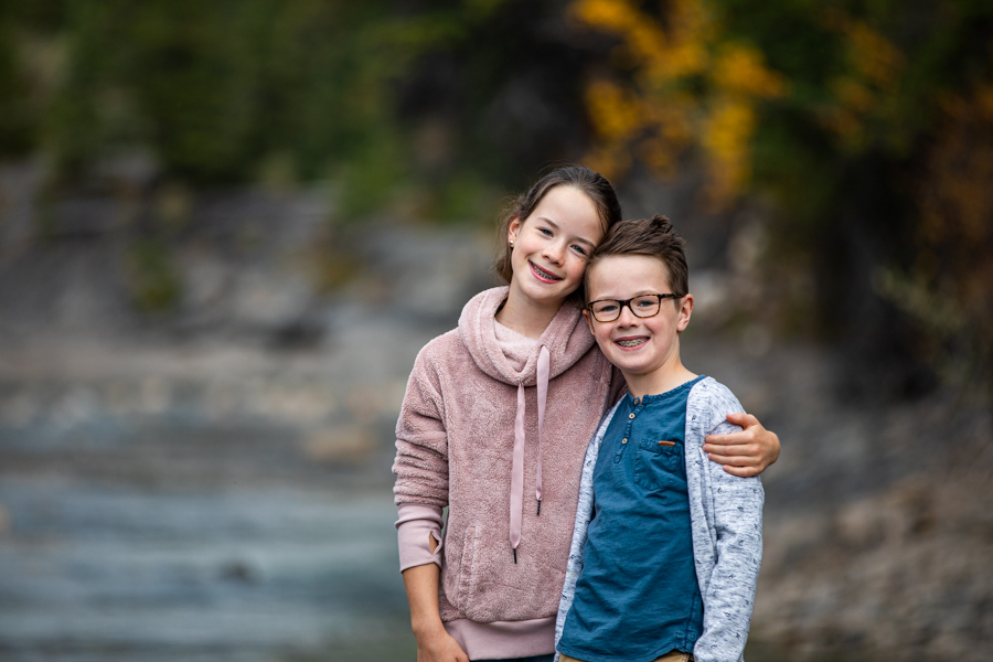 siblings posing for a family photo