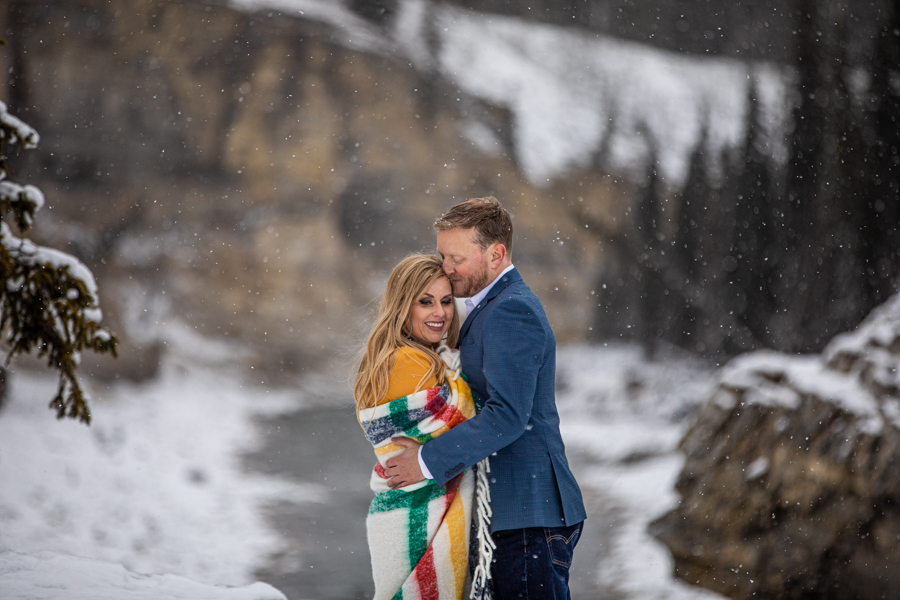 couple snuggling for Elbow Falls Engagement